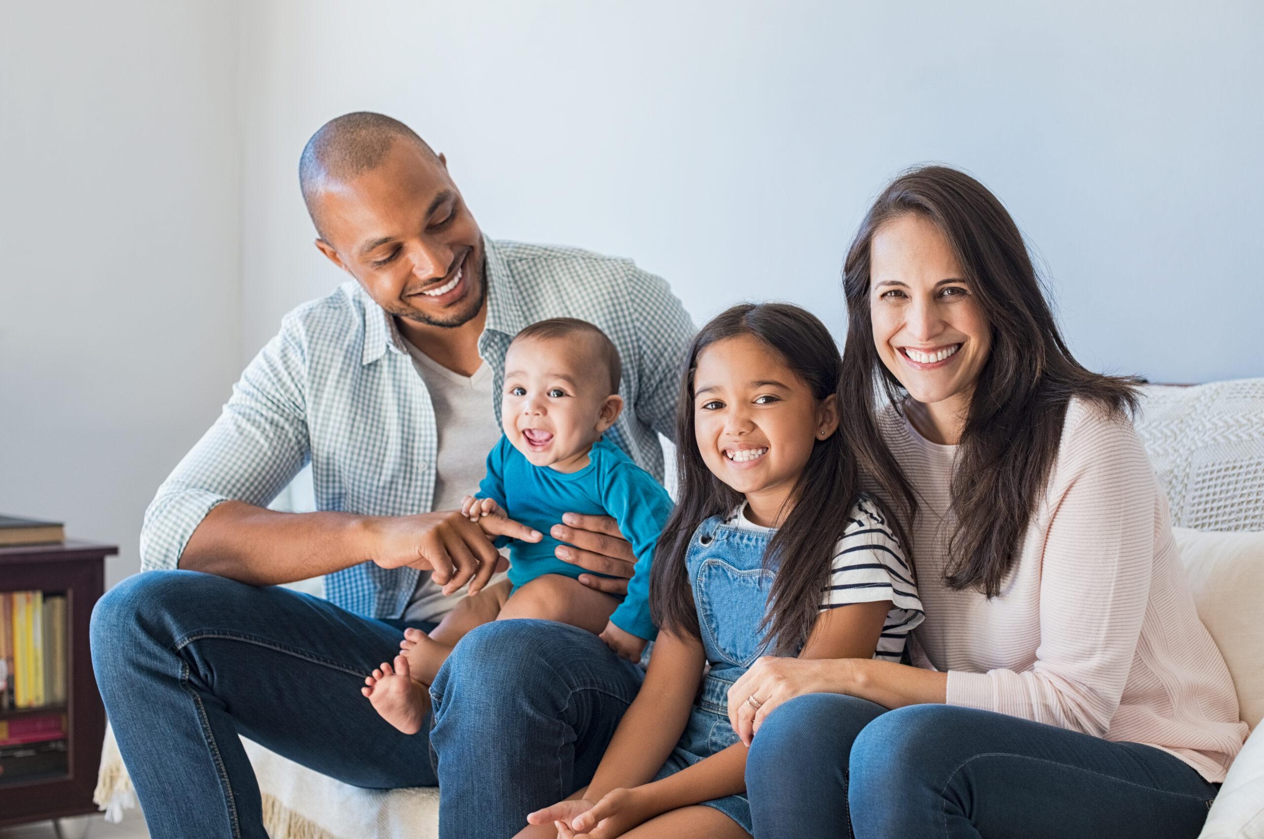 Happy multiethnic family on sofa